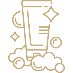 Gold icon of a glass with a straw and cloud elements on a white background