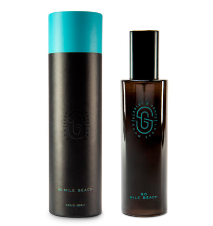 200ml 90 Mile Beach room spray styled with natural stone and palm shadows — oakmoss and sea spray fragrance notes

